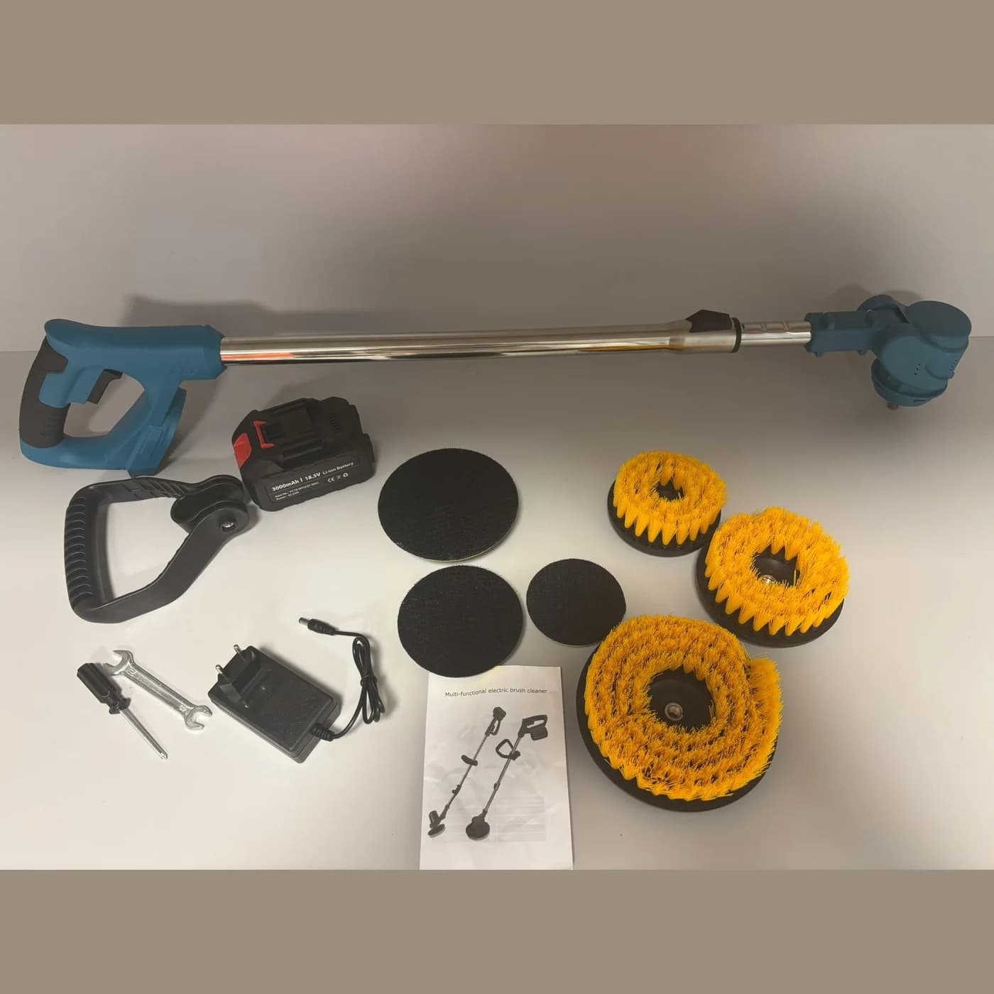 Everything in the order laid out: scrubber, battery, side handle, six heads, tools and instructions