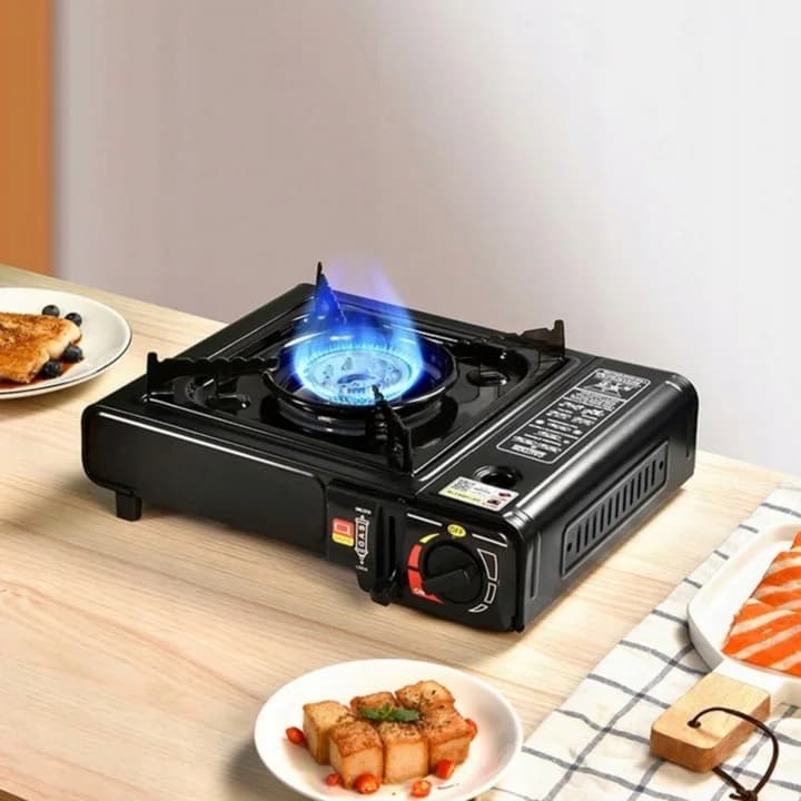 Camping stove alight on a wooden table